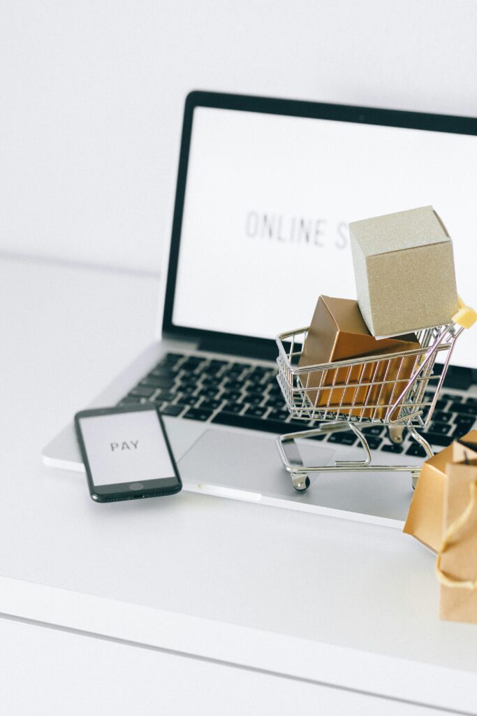 pexels-photo-6214470-6214470 Mini shopping cart on laptop symbolizing online shopping and e-commerce transactions. E-poe tegemine